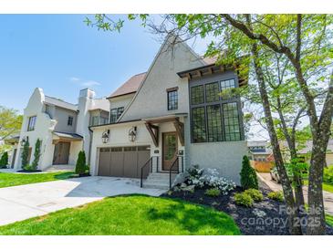 Stunning two-story home boasts a brick exterior, a two-car garage, and beautiful landscaping at 410 Mcalway Rd, Charlotte, NC 28211