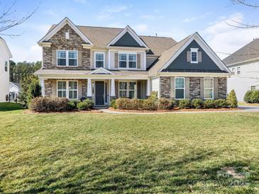 Charming two-story home featuring stone accents and a well-manicured front yard at 5078 Hyannis Ct, Matthews, NC 28104