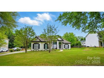 Charming two-story home featuring classic white paint and black trim and shutters at 530 Dovefield Dr, Indian Trail, NC 28079