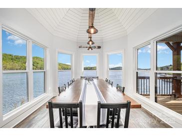 Stunning dining room featuring lake views, modern lighting, and large dining table with seating at 602 Shoreline Rd # 144, New London, NC 28127