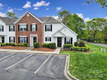 Charming townhome featuring brick and vinyl siding, black shutters, and manicured landscaping for great curb appeal at 901 Heritage Pkwy, Fort Mill, SC 29715