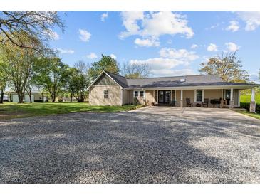 Charming single-story home with a covered porch, gravel driveway, and well-maintained landscaping at 14855 Nc 801 Hwy Hwy, Mt Ulla, NC 28125