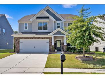 Charming two-story home with a manicured lawn, a two-car garage, and stylish exterior features at 15127 Oleander Dr, Charlotte, NC 28278