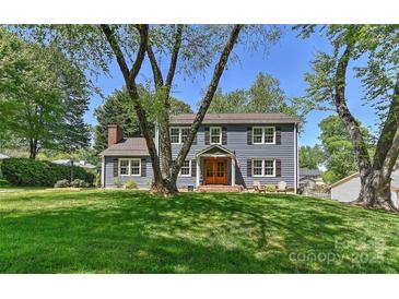 Charming two-story home with a well-maintained lawn, wood trim and inviting front porch at 218 Kimrod Ln, Charlotte, NC 28270