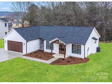 Charming single-story home with white siding, a dark roof, and a well-manicured lawn at 28647 Nc Hwy 73 Hwy, Albemarle, NC 28001