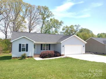 Charming single-story home with a well-maintained lawn and attached two-car garage at 295 Green Meadows Dr, Taylorsville, NC 28681