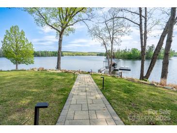 View of lake from backyard through landscaped path leading to private dock at 302 Patterson'S Bridge None, New London, NC 28127