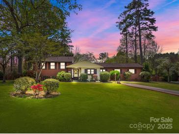 Charming brick home with a well-manicured lawn and beautiful landscaping at 365 Pine Hill Rd, Salisbury, NC 28144