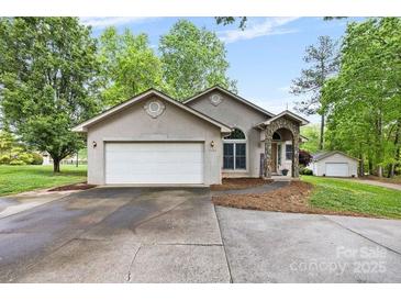 Charming stucco home with a two-car garage, stone accents, and a well-manicured front yard at 3764 Glenn Oaks Dr, Maiden, NC 28650