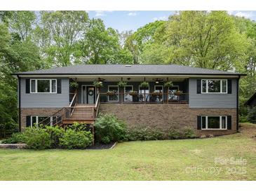 Charming home featuring a welcoming front porch with decorative plants and fans at 4517 Lake Shore N Rd, Denver, NC 28037