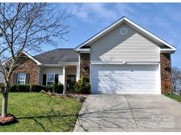 Charming single-story home featuring a two-car garage, brick accents, well-maintained lawn, and concrete driveway at 5927 Patricia Ryan Dr, Charlotte, NC 28216