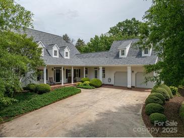 Charming two-story home with three-car garage, a brick driveway, and a landscaped front yard at 7701 Gold Hill Rd, Rockwell, NC 28138