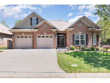 Charming brick home featuring a two-car garage, a well-manicured lawn, and decorative shutters at 106 Independence Ct, Kings Mountain, NC 28086