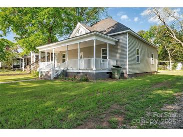 Charming home featuring a cozy front porch with a white railing and a well-manicured lawn at 126 Hemphill Ave, Chester, SC 29706