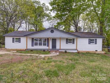 Charming single-story home with a freshly painted white brick exterior and well-maintained front yard at 163 Briarcliff Dr, Kannapolis, NC 28081