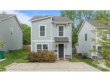 Charming two-story home featuring a gray siding, stylish windows, and a well-manicured front yard at 2821 Shamrock Dr, Charlotte, NC 28205