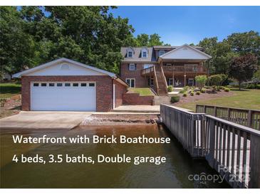 Stunning waterfront home with brick boathouse and double garage, featuring 4 beds and 3.5 baths at 378 Shoreline Dr, New London, NC 28127