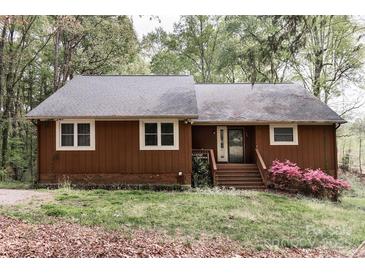 Charming, single-story house with a brown exterior, gray roof, and landscaped front yard at 948 Kingswood Dr, Rock Hill, SC 29732