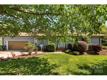 Charming home exterior boasts lush landscaping and a well-maintained lawn at 1012 Woodlark Ct, Gastonia, NC 28056
