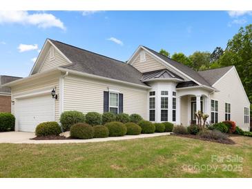 Charming home featuring a well-manicured lawn, attached two-car garage, and inviting architectural details at 1488 River Bend Blvd, Fort Mill, SC 29707