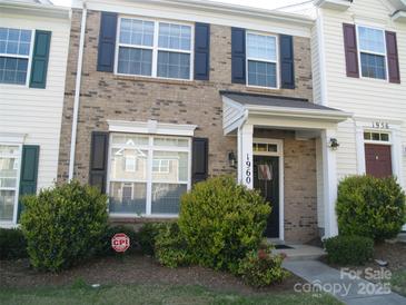 Charming two-story townhome with brick facade, black shutters, and a well-manicured front yard at 1960 Aston Mill Pl, Charlotte, NC 28273