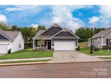 Charming single-Gathering home featuring a two-car garage and manicured lawn at 2219 Catawba Trace Dr, Catawba, NC 28609
