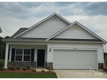 Charming single-story home with white siding, stone accents, and an attached two-car garage at 2219 Catawba Trace Dr, Catawba, NC 28609