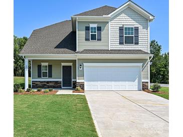 Charming two-story home with a well-maintained lawn, stone accents, and a two-car garage at 2226 Catawba Trace Dr # 11, Catawba, NC 28609