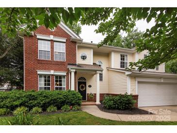 Charming two-story home featuring a blend of brick and siding, complemented by manicured landscaping at 3404 Pasture View Ct, Charlotte, NC 28269