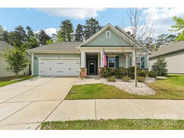 Charming single-story home features a two-car garage and inviting front porch at 476 Dudley Dr, Fort Mill, SC 29715
