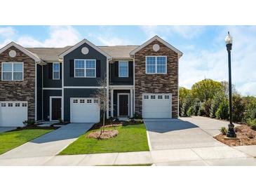 Charming townhomes with individual garages, stone accents, and well-manicured lawns create inviting curb appeal at 6153 Helens Rest Ln, Lincolnton, NC 28092