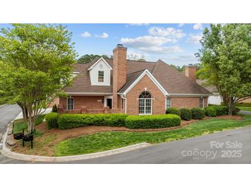 Beautiful brick home features mature landscaping, a prominent chimney, and well-manicured lawn at 7502 Hurstbourne Green Dr, Charlotte, NC 28277