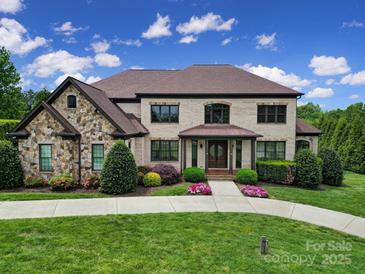Beautiful two-story home featuring stone accents, manicured landscaping, and a welcoming front entrance at 802 Capington Ln, Waxhaw, NC 28173