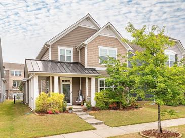Charming two-story home featuring a cozy front porch and beautifully landscaped front yard at 8065 Cornhill Ave, Charlotte, NC 28277