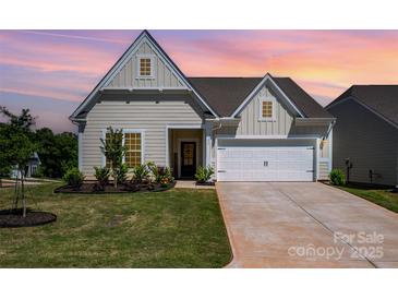Charming single-Gathering home featuring manicured lawn and attached two-car garage at 153 Pampas Pl, Statesville, NC 28625