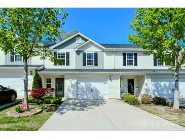 Charming townhome with a well manicured front yard and driveway that leads up to a two-car garage at 2141 Talbert Ct, Charlotte, NC 28214