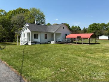 Charming cottage-style home with a well-maintained lawn and a convenient carport at 4787 Rock Barn Rd, Claremont, NC 28610