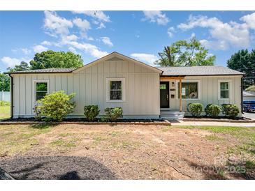 Charming renovated ranch-style home featuring new siding and well-maintained landscaping at 504 N Hawthorne St, Mount Holly, NC 28120
