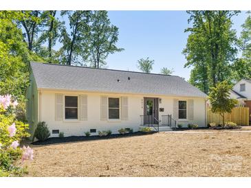 Charming, renovated single-story home with painted brick, manicured landscaping, and a welcoming front entrance at 5514 Milford Rd, Charlotte, NC 28210