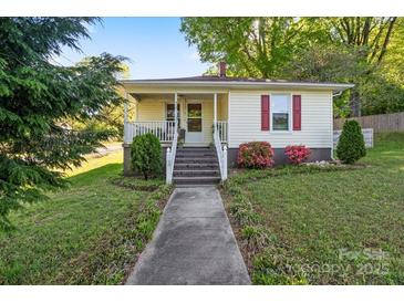 Charming home featuring a cozy front porch, landscaped yard, and classic design at 912 W A St, Kannapolis, NC 28081