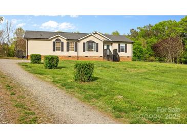Charming single-Gathering home with classic curb appeal, neat landscaping and gravel driveway at 1821 Hopewell Church Rd, Hiddenite, NC 28636