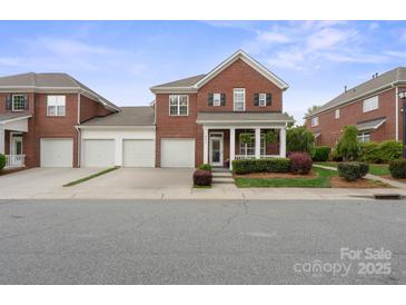 Charming brick home featuring a welcoming front porch, well-maintained landscaping, and a spacious two-car garage at 20217 Middletown Rd, Cornelius, NC 28031