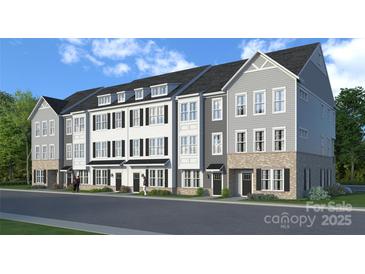 Modern townhome exteriors featuring multi-story facade with gray and white siding and brick foundations at 236 Wesser St # 3, Davidson, NC 28036