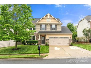 Charming two-story home with stone accents, a well-manicured lawn, and a spacious two-car garage at 3039 Keswick Ter, Indian Land, SC 29707