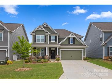 Charming two-story home with a well-manicured lawn and inviting curb appeal, painted in a neutral green tone at 3129 Burnello Ct, Iron Station, NC 28080