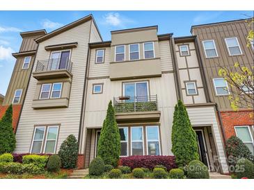 Modern townhome showcasing a multi-level facade with balconies, stylish windows, and professional landscaping at 3216 Moss Ln, Charlotte, NC 28206