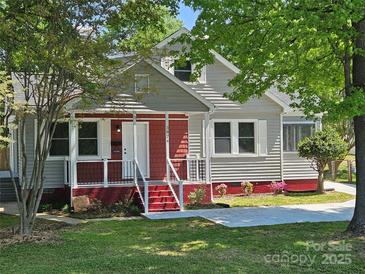 Charming two-story home with a welcoming front porch and well-maintained lawn at 3824 Freedom Dr, Charlotte, NC 28208