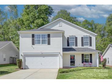 Charming two-story home featuring a two-car garage, neat landscaping, and a welcoming front porch at 599 Annalinde Ln, Rock Hill, SC 29732