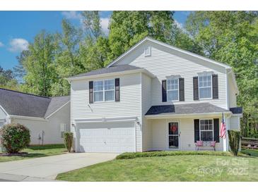Charming two-story home featuring a two-car garage, neat landscaping, and a welcoming front porch at 599 Annalinde Ln, Rock Hill, SC 29732