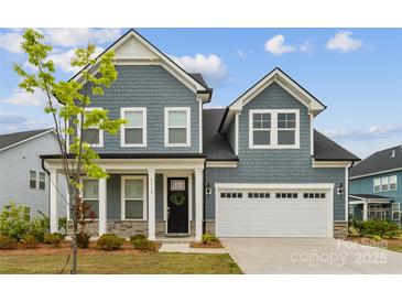 Charming two-story home with blue siding, a two-car garage, and a welcoming front porch in a well-kept neighborhood at 6114 Alsace Ln, Indian Land, SC 29707